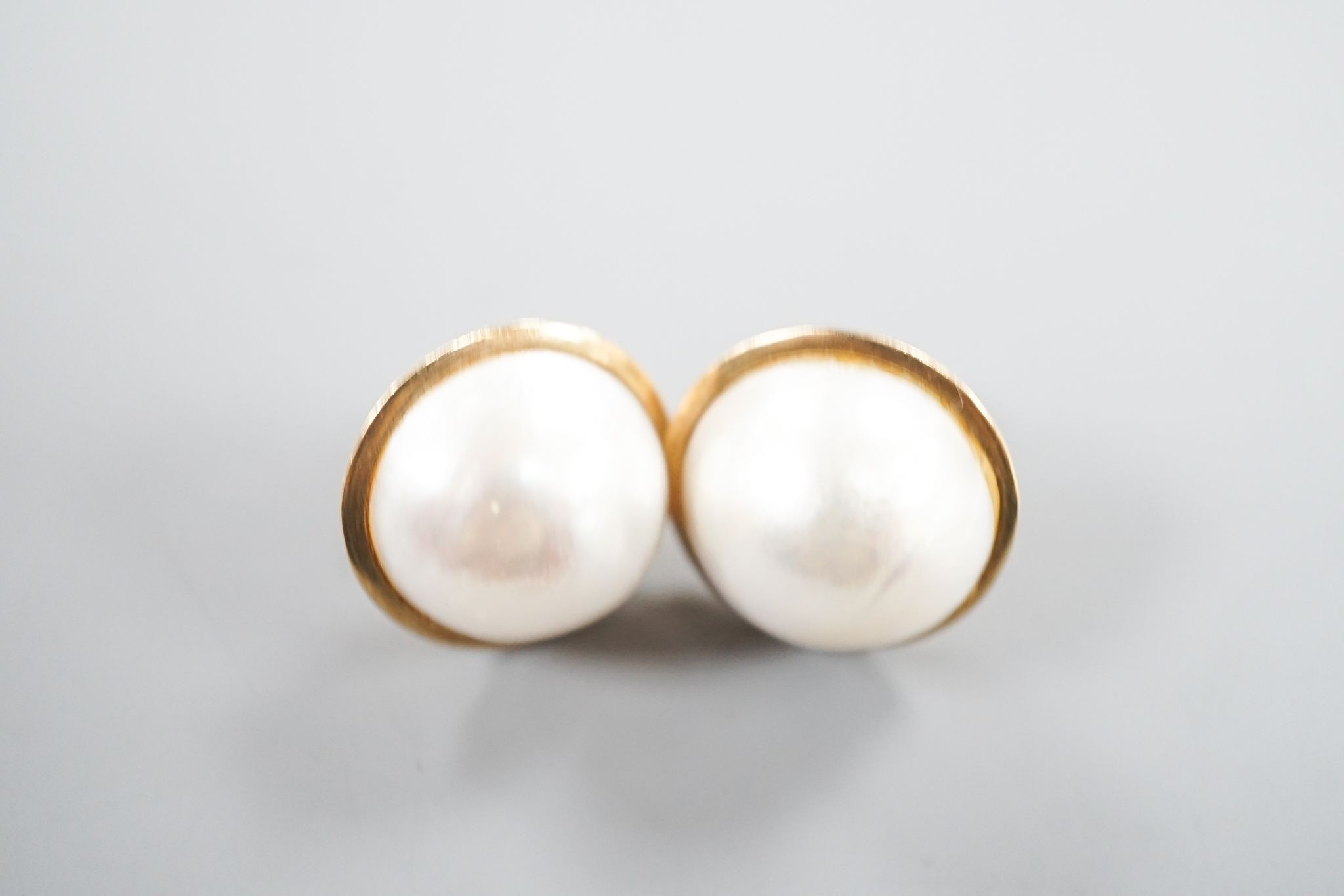 A pair of yellow metal and mabe pearl earrings, 2mm, gross weight 13.3 grams.
